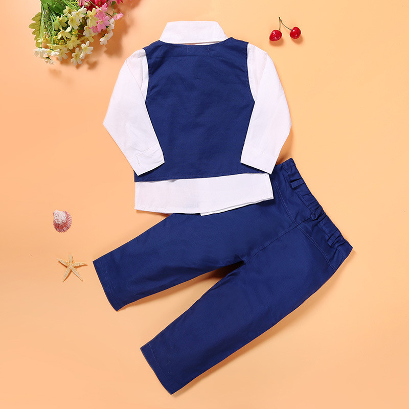 Boys gentleman suit set with white shirt, blue vest and blue pants laid flat